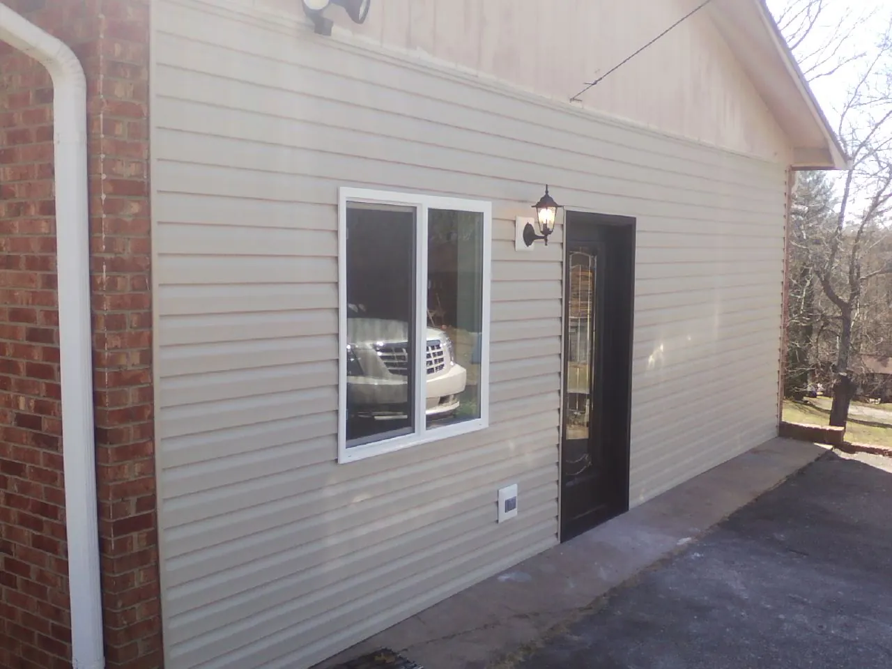 New vinyl siding and entry door on a room addition in Atlantic Beach